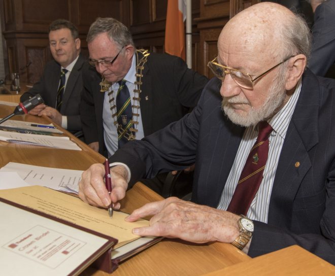 Professor Campbell signing the distinquished visitors book.