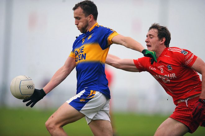 Kilcar's Ciaran Mc Ginley  against Hugh McFadden of Killybegs