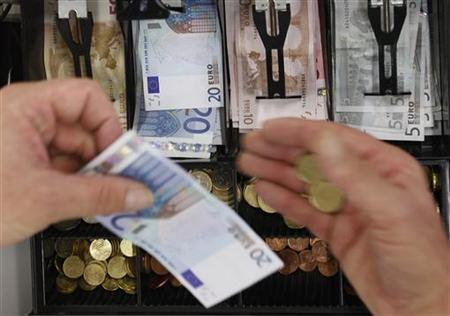 Euro banknotes and small coins are pictured in open cash register in Olching