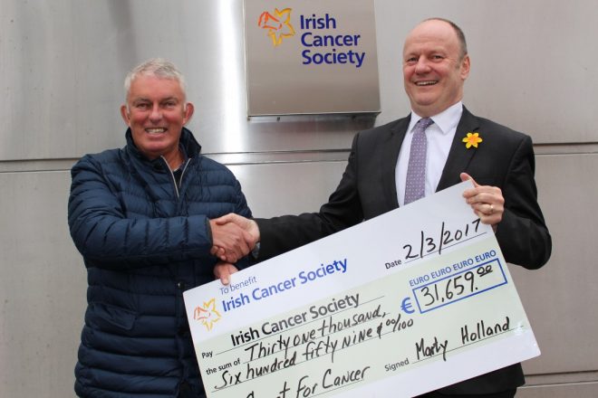  Dr Marty Holland presents the proceeds from the first leg of his Coast for Cancer challenge to Mark Mellett, Head of Fundraising, Irish Cancer Society.