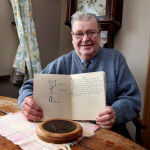 Tom Hamilton with the copybook and death penny. Photography by Declan Doherty