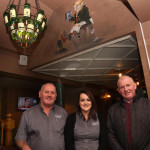 Brian Brogan with staff members John and Regina in the newly refurbished Tr na Ng bar this week, under the unique Jameson bottle chandelier.