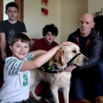 Dermot Connolly with his brothers Declan and James, father Gerry and autism therapy dog Lionel.