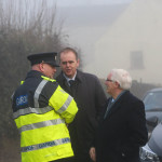 Joe McHugh, TD and Cllr Bernard McGuinness speaks with a garda outside the funeral of Paddy Harte OBE.