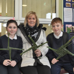 Cadhla and Caolan pictured with the granny Rosie McGlinchey at the grandparents day were they made St Brigets Crosses in Donnyloop.