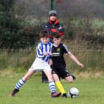 Daniel Gillespie, Illistrin gets the ball away despite the challenge by Colm Shivnan, Oranmore. Photo: Donna El Assaad