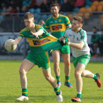 Lorcan O'Donnell, Ardara is challenged by Andrew McCloskey, MacCumhaills. Photo: Donna El Assaad