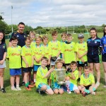 Donegal player Martin O'Reilly with coaches and children taking part in the St Mary's, Convoy, Kellog's Cul Camp delighted to get their hands on the Anglo-Celt Cup this week.